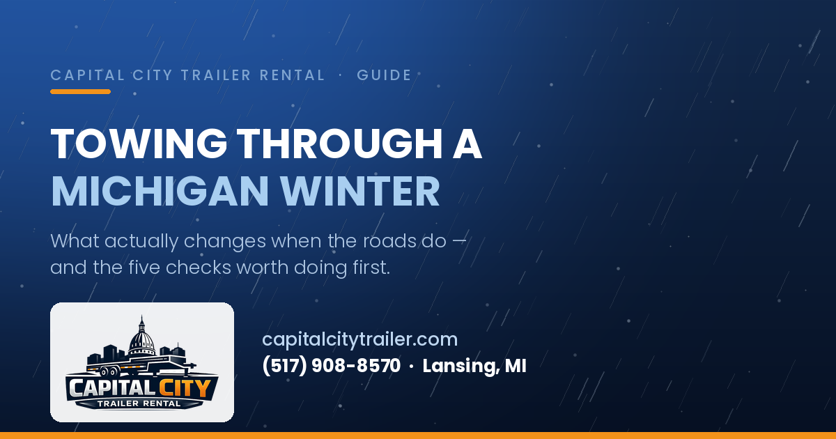 Snow blowing across a dark road at night — a guide to winter towing in Michigan from Capital City Trailer Rental in Lansing